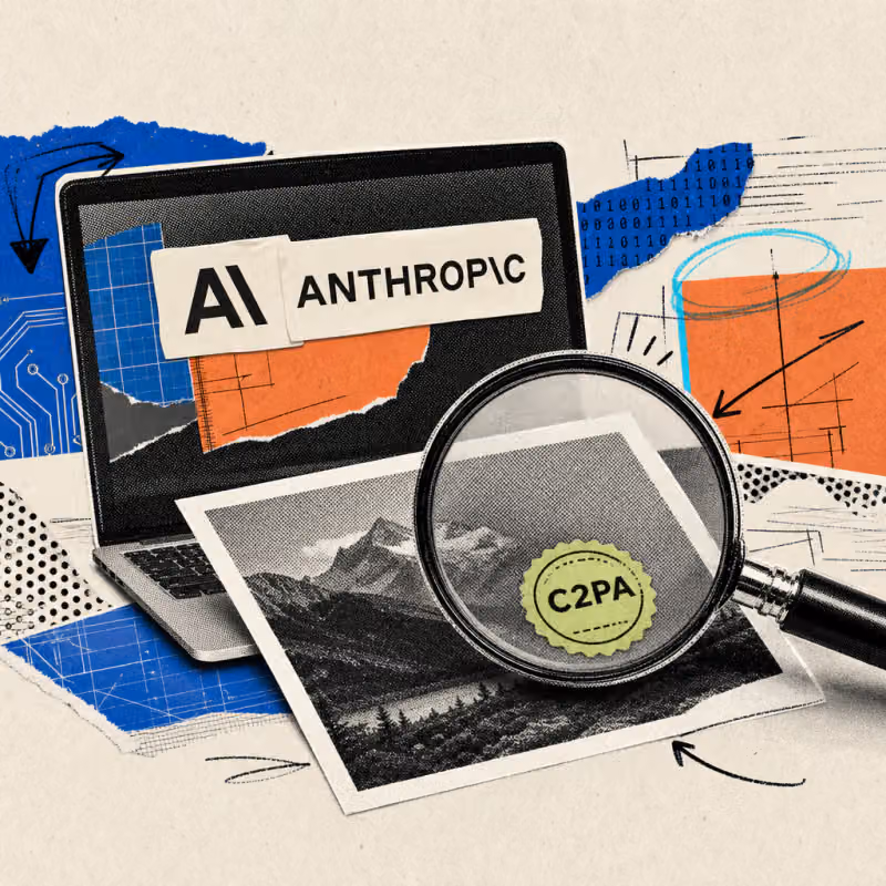 A magnifying glass hovers over a printed photo, revealing a round seal reading C2PA underneath; in the background, a laptop screen carries an Anthropic logo sticker.